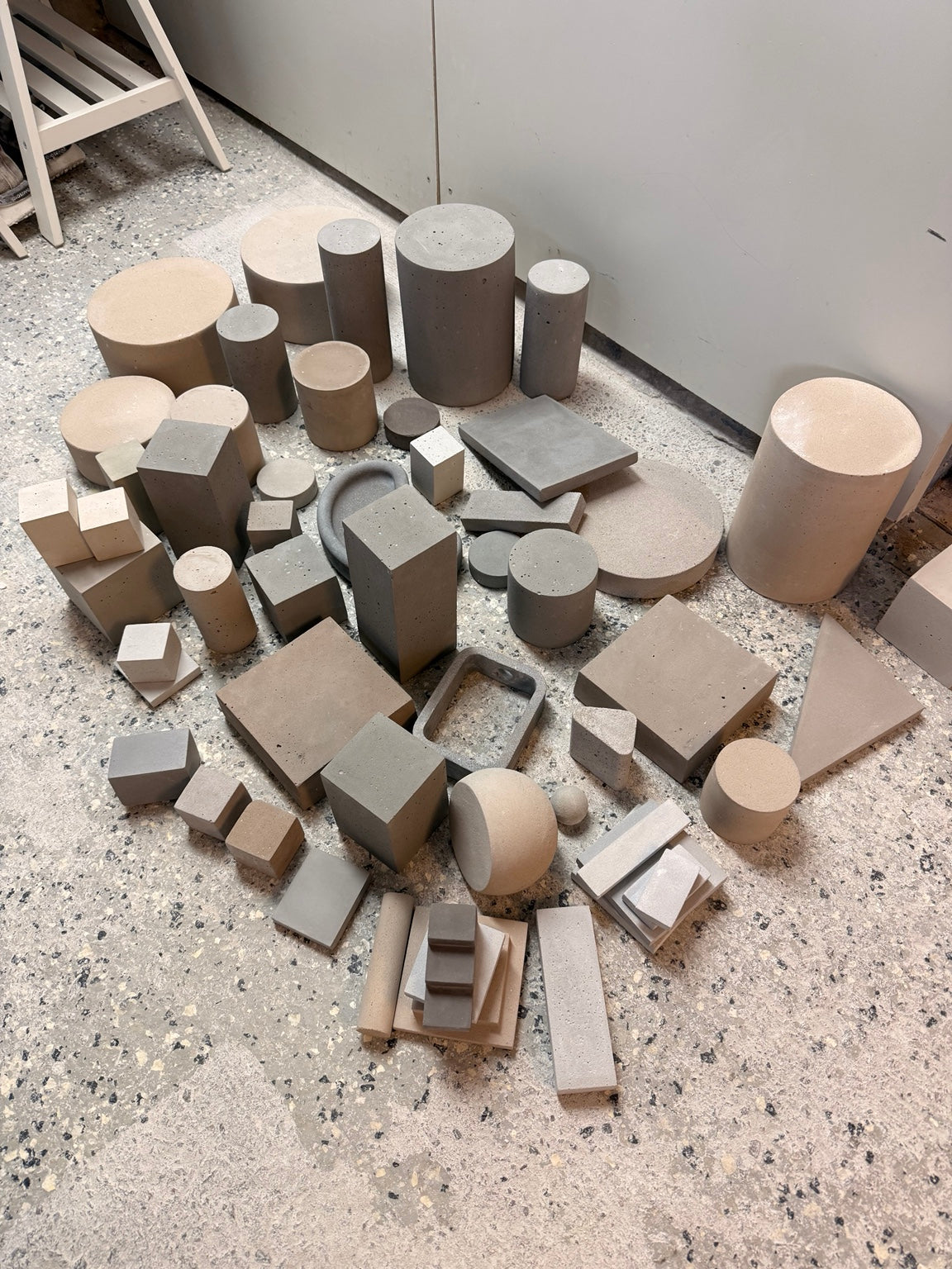 Assortment of mineral cylinders, cubes, slabs and geometric risers in different sizes