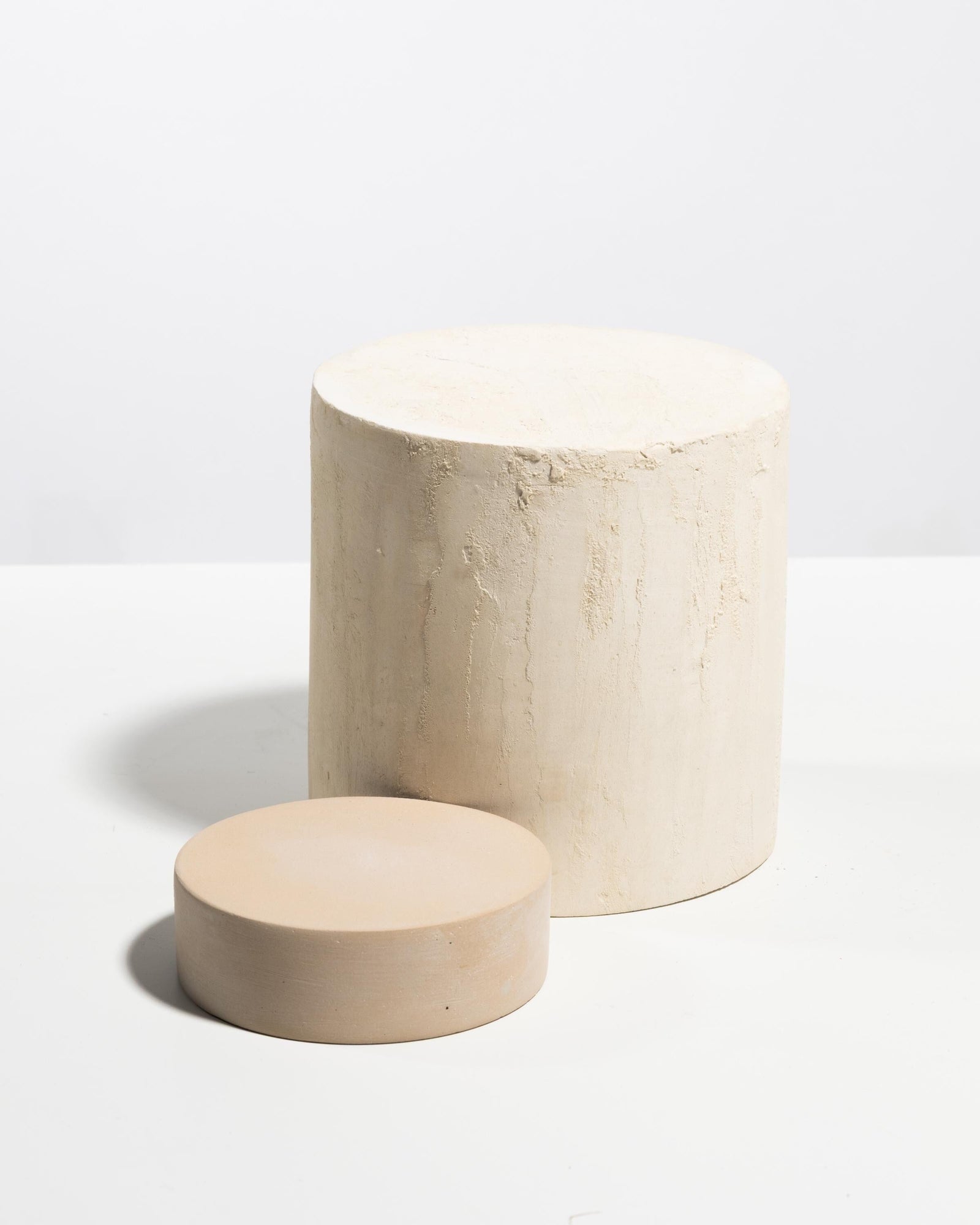 Betonvton beige cylinder display pedestals for bakery counters, packaged goods and product styling