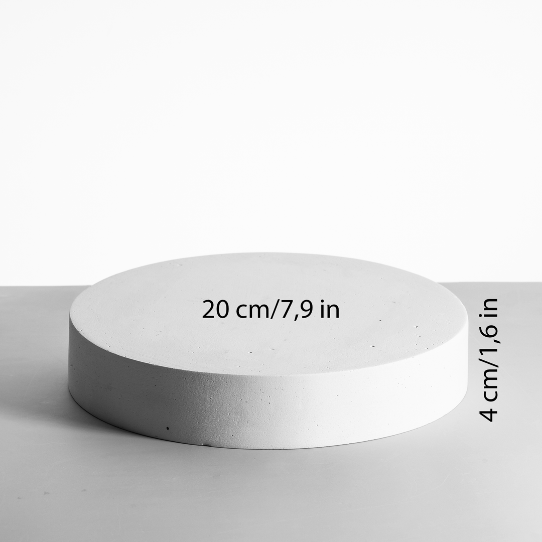 Round concrete block with measurements on a light gray background