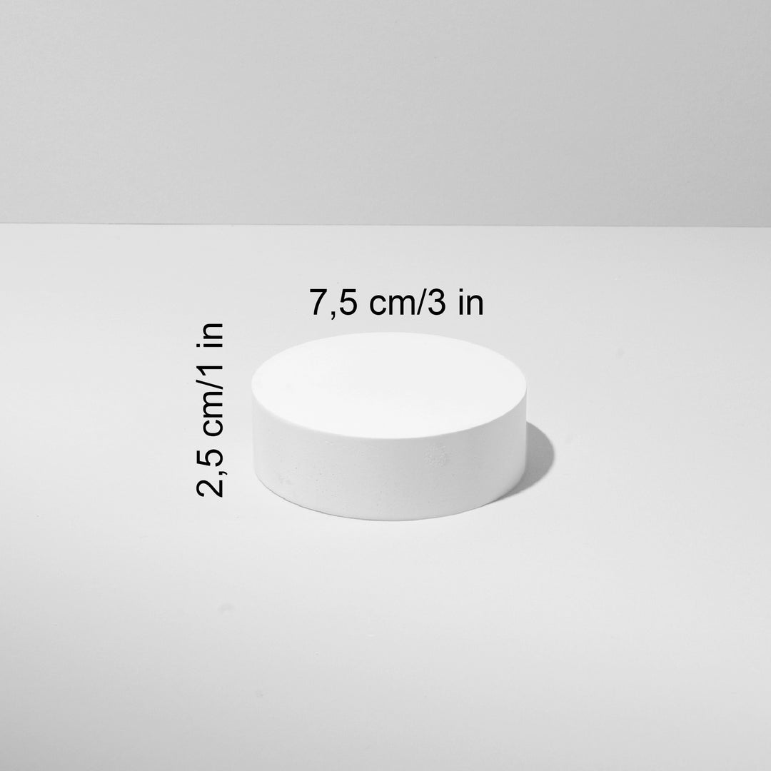 White cylindrical object with measurements on a light gray background