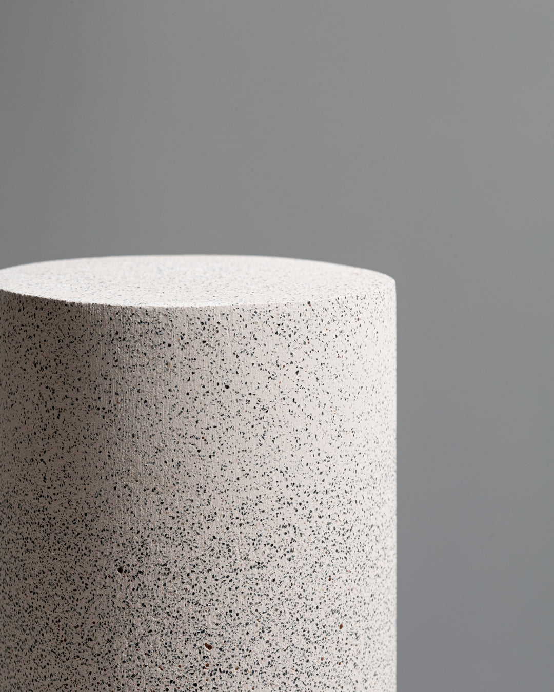 Concrete cylindrical dusty pink speckled  vase and display pedestal with black sand texture