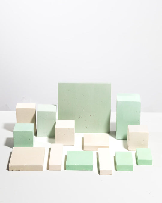 Set of geometric display blocks in pale mint green and soft cream tones