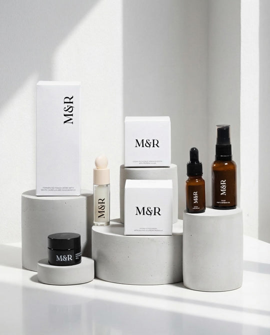 Concrete cylinder risers with luxury skincare packaging for retail presentation