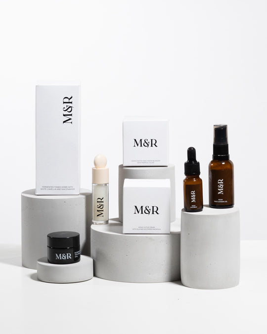 Minimal skincare merchandising setup with plaster podiums and luxury cosmetic packaging