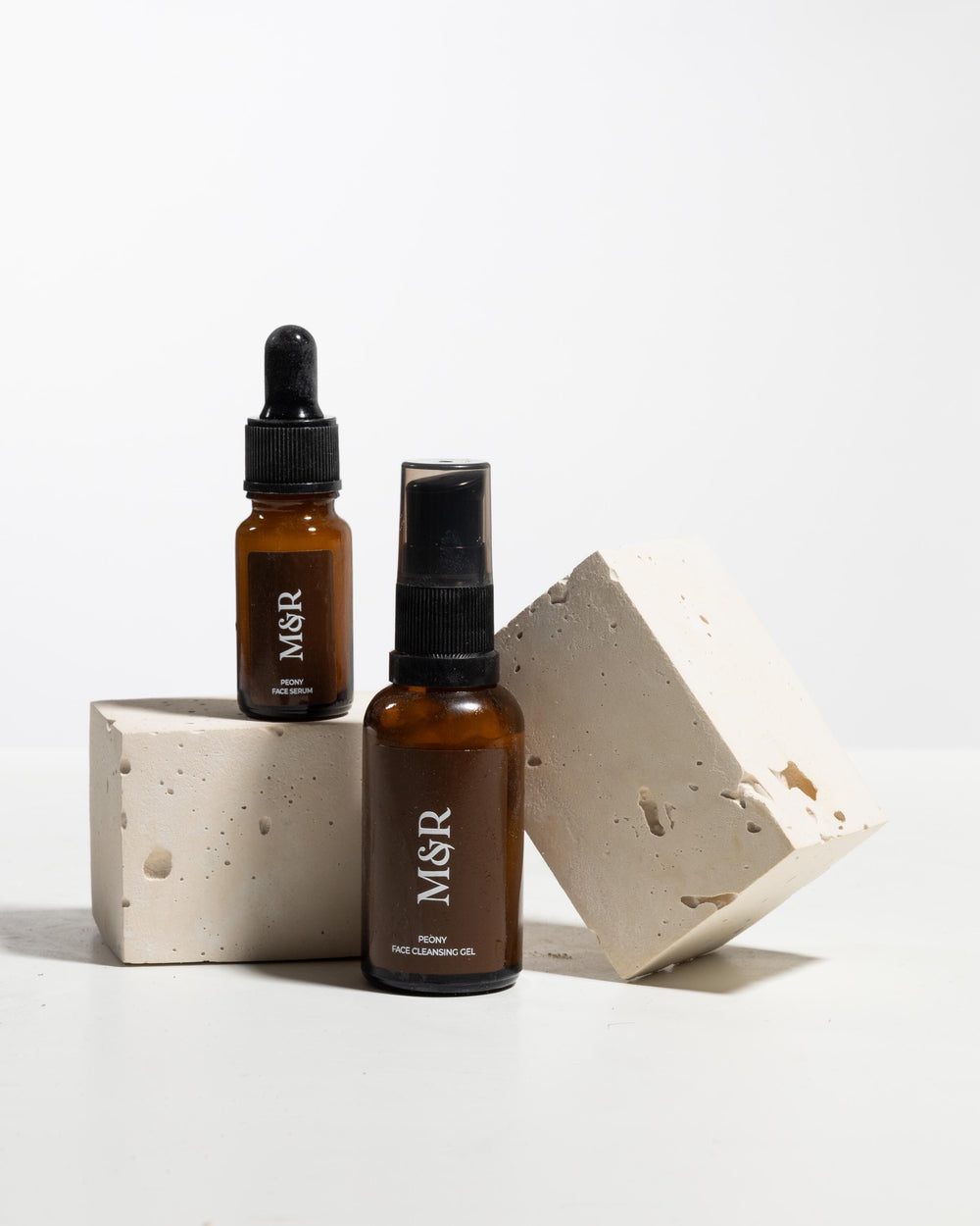 Ivory display blocks styled with skincare bottles for product photography