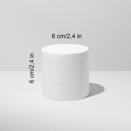 Grey and white cylinder pedestals styled for product presentation