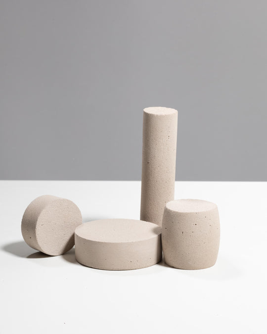 Light beige plaster jewelry display set with tall cylinder, wide pedestal, disc and barrel piece