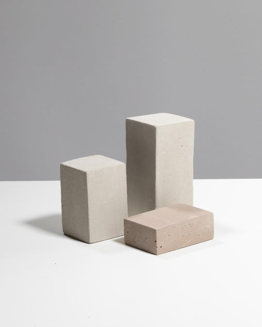 Grey beige plaster display riser trio with three rectangular blocks at different heights