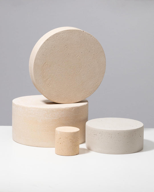 Beige and light grey plaster pedestal and disc set for perfume and candle display