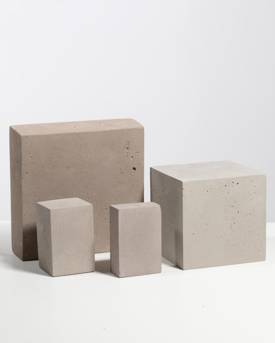 Grey and beige plaster block riser set of four for product display