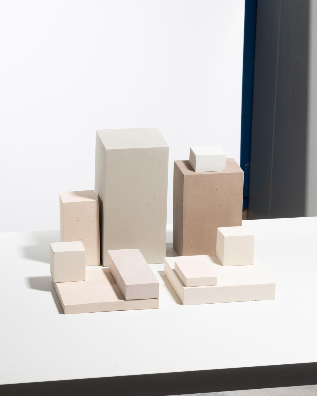 Geometric display blocks in beige, cream and tan tiered arrangement