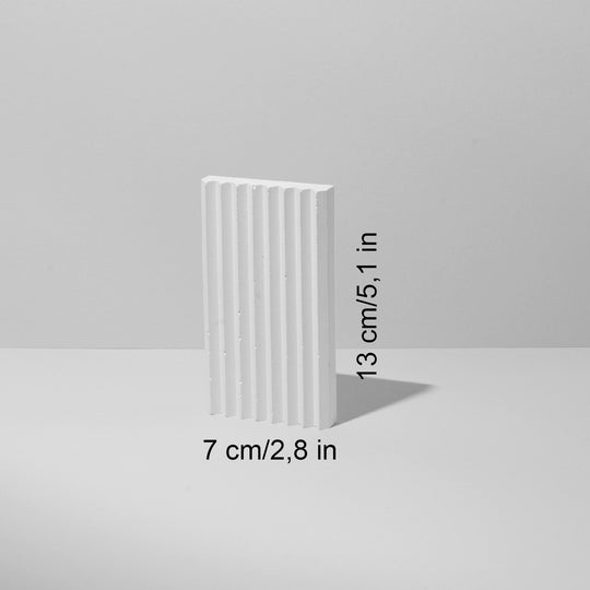 White plaster wave riser styled with products for boutique presentation