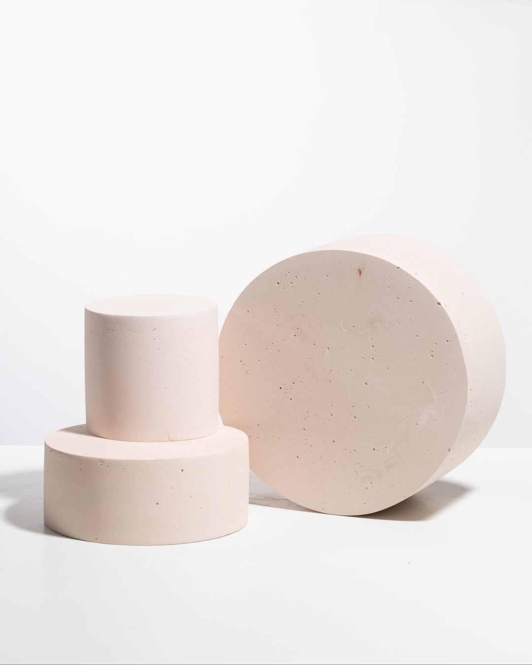 Blush pink cylinder pedestal set styled for product photography