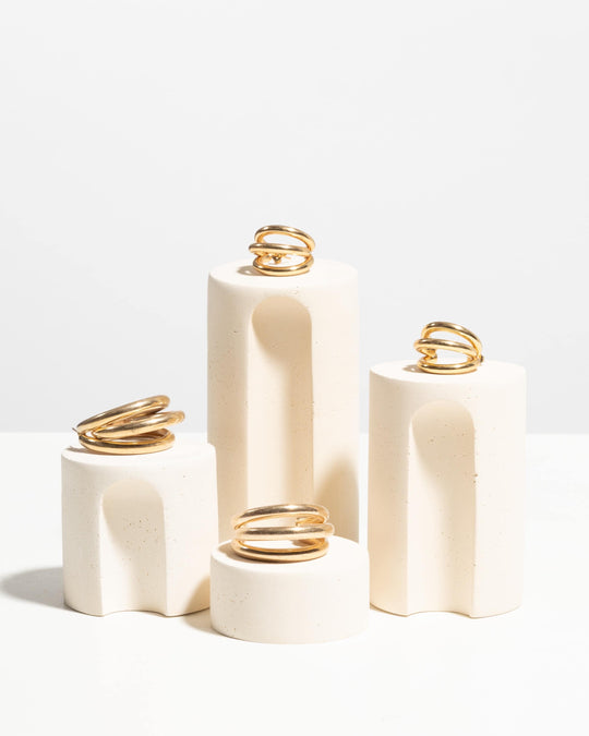 Off white arched cylinder jewelry podium set of four in speckled plaster