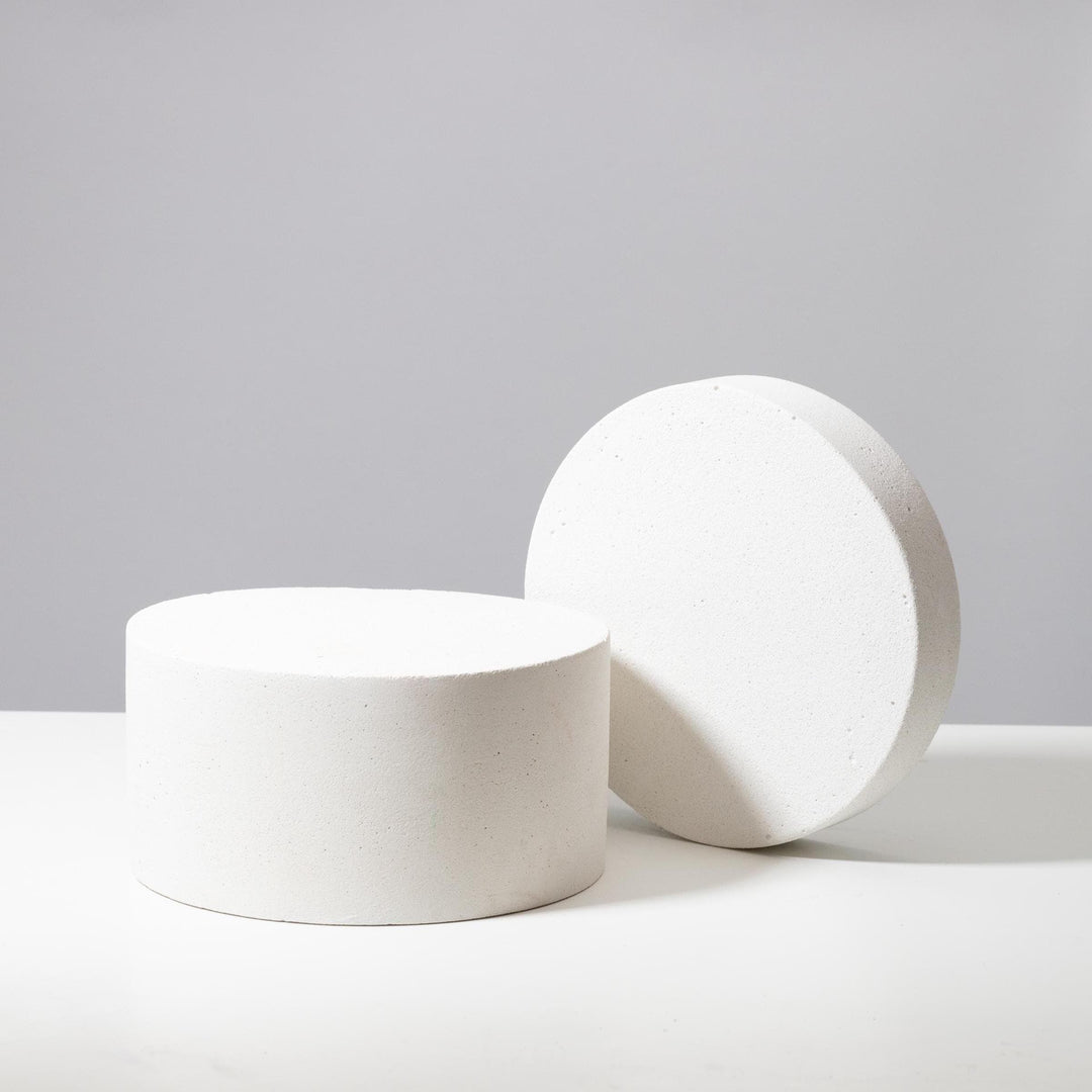 Light grey round display platforms styled for retail presentation