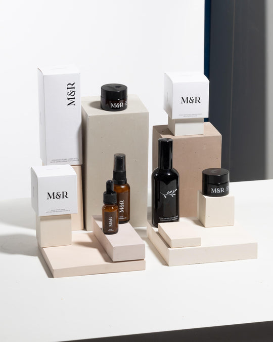 Skincare display stand set styled with serums, dropper bottles and jars